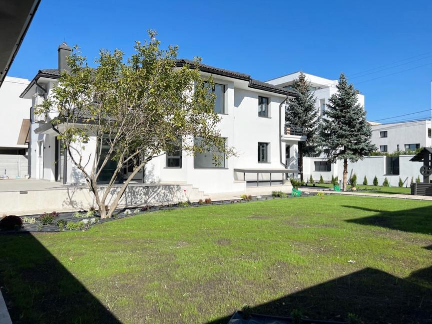 Completed residential building exterior with landscaped garden